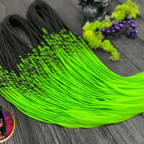 Set of thin synthetic dreads in black to bright green hair extensions