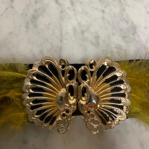 Black stretch belt with peacock buckle and spotted feather embellishment.  One of a kind.  One size