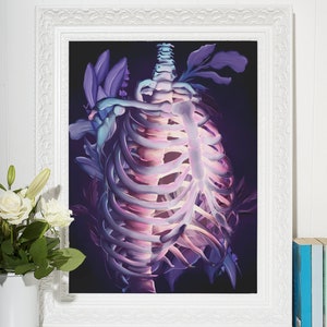 May include: A framed illustration of a ribcage with purple and blue flowers growing around it. The background is dark and the ribcage is glowing.