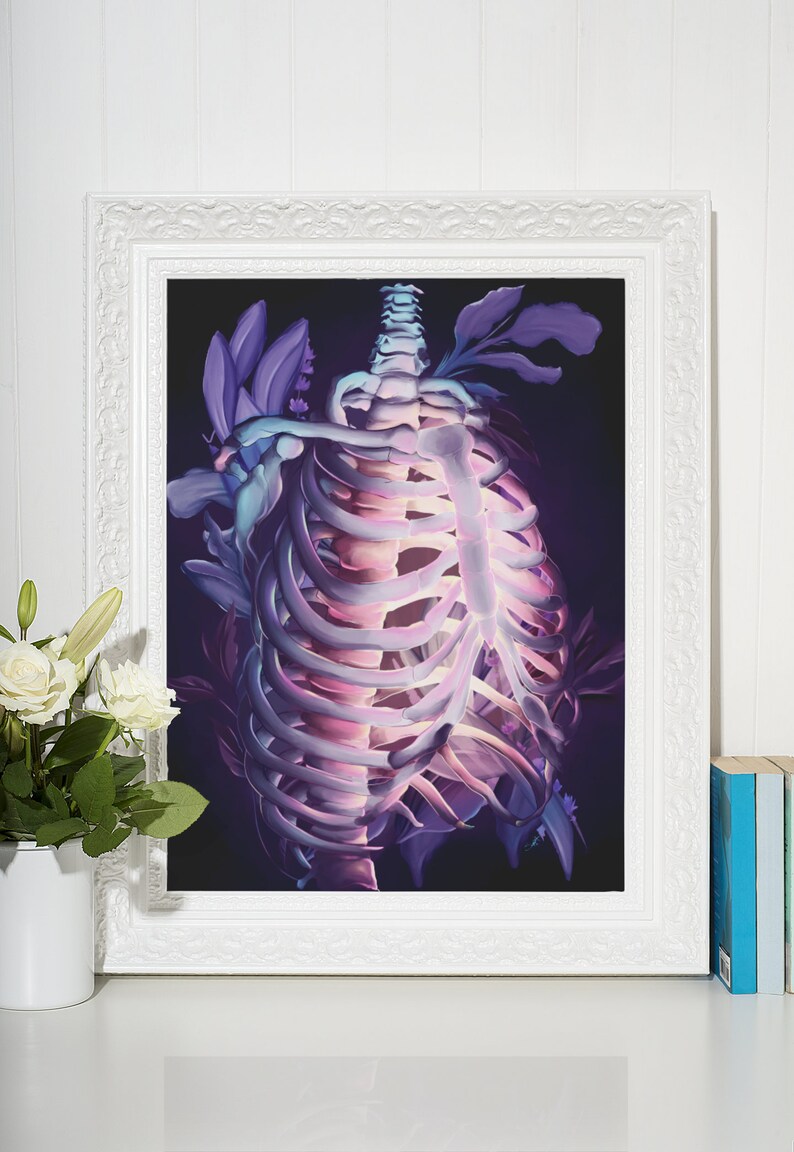 May include: A framed illustration of a ribcage with purple and blue flowers growing around it. The background is dark and the ribcage is glowing.