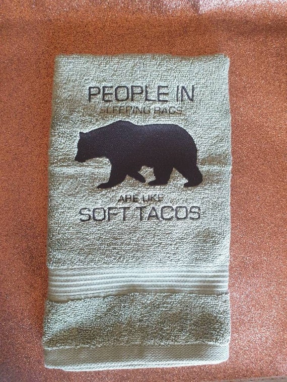Embroidered novelty towel . Novelty gift . Camping Towel , people In sleeping bags are like soft tacos ,