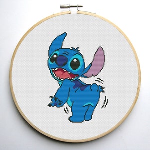 May include: A blue and purple Stitch character from the Disney movie Lilo & Stitch, with big eyes and a wide smile, is shown in a cross-stitch pattern.