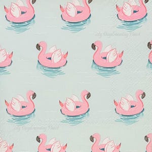 May include: A light blue paper napkin featuring a repeating pattern of pink flamingo pool floats on blue water. The text My Daydreaming Heart is printed in a light script font across the surface of the napkin among the flamingo illustrations.