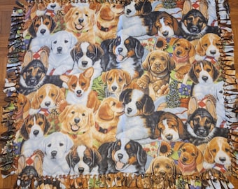 May include: A colorful fleece blanket featuring a collage of various dog breeds. The blanket showcases a variety of dogs in different poses and colors, with a ruffled edge. The design includes golden retrievers, beagles, and other breeds.