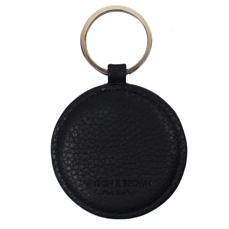 May include: Black leather key chain with a round tag that says "BYRON BARROW Fine Leather".