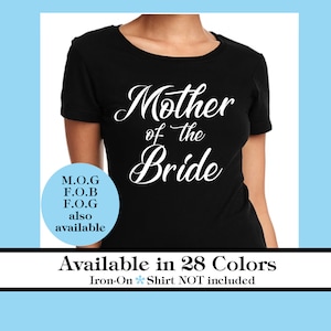 May include: Black t-shirt with white text that reads "Mother of the Bride". The text is in a cursive font. The shirt is available in 28 colors. Iron-on is included, but the shirt is not.