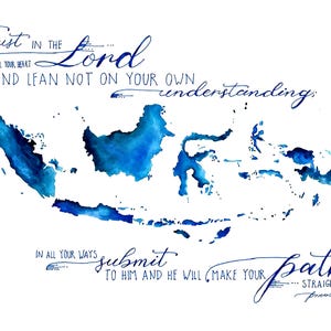 May include: A white print featuring a watercolor map of Indonesia in shades of blue. The text "Trust in the Lord" and a Bible verse are written in elegant blue script, creating a spiritual and artistic design.