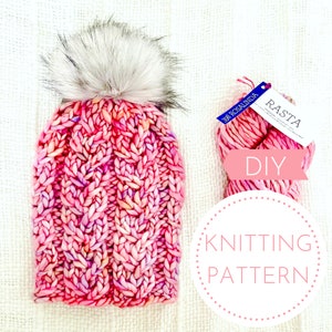 May include: DIY knitting pattern for a pink and white cable knit beanie with a faux fur pom pom. The yarn is called "Rasta" and is a pink and white ombre color.