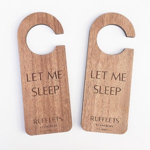 May include: Two wooden door hangers with the text "Let Me Sleep" and the name "Rufflets" with the location "St Andrews" and the year "1924".