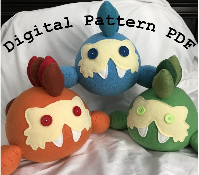 May include: Three plush toys, each with a different color and design. The first toy is orange with brown spikes and red buttons for eyes. The second toy is blue with a white mask and blue buttons for eyes. The third toy is green with a white mask and green buttons for eyes.  The toys are all lying on a white surface.  Digital Pattern PDF.