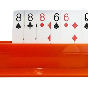 May include: A set of playing cards arranged in a card holder. The cards include 8 of spades, 8 of clubs, 8 of diamonds, 6 of spades, 6 of diamonds, Queen of spades, Queen of hearts, Queen of hearts, 10 of hearts, 10 of spades, Jack of clubs, Jack of spades, Jack of hearts, Jack of diamonds, and Jack of hearts.