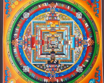 May include: A colourful mandala with intricate details and a square pattern in the centre. The mandala is surrounded by a circle of text in a foreign language. The background is orange.