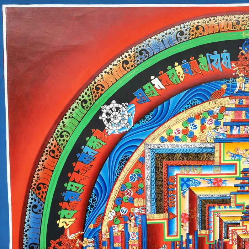 May include: A colorful mandala painting with intricate details and a blue, green, and gold border. The mandala is surrounded by a red background and features a wheel of dharma in the upper left corner.