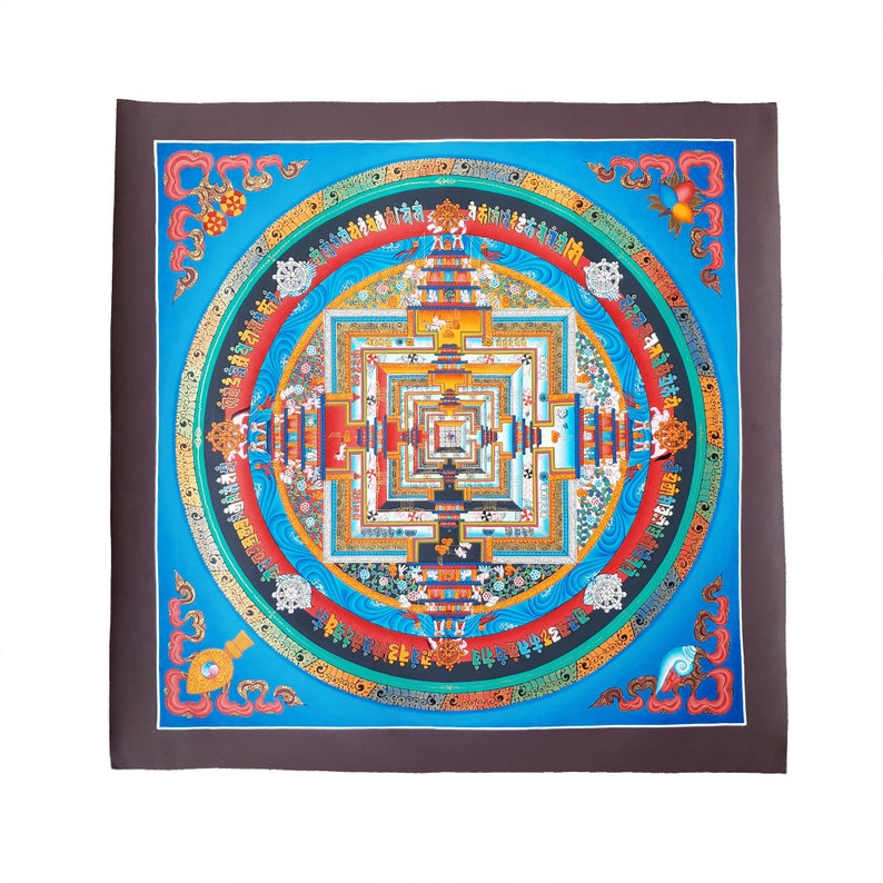 May include: A colourful mandala with intricate details and a square frame. The mandala is painted on a canvas with a dark brown border. The mandala features a central square with concentric squares and circles, surrounded by a ring of text and images.