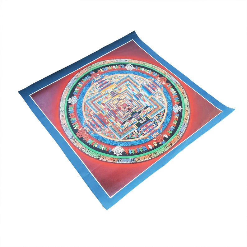 May include: A colorful mandala print on canvas with a blue border. The mandala features intricate details and patterns in shades of red, blue, green, and yellow.