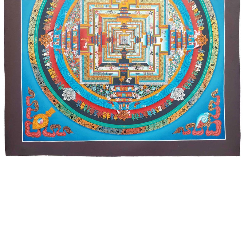 May include: A colourful mandala with a blue background and intricate details. The mandala is surrounded by a border of gold and red. The centre of the mandala is a square with a smaller square inside. The mandala is a traditional Tibetan Buddhist symbol of the universe.