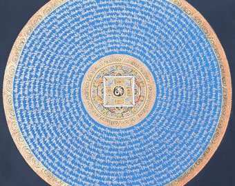May include: A circular mandala with a blue background and gold accents. The mandala features a central square with a stylised symbol and is surrounded by concentric circles of intricate patterns and text in a Tibetan script.