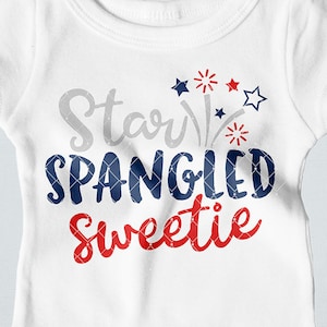 May include: White baby onesie with the words "Star Spangled Sweetie" in gray, navy blue, and red. The design includes star and firework graphics. The onesie is a short-sleeved garment with snap closures.