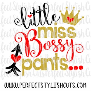 May include: A black and gold design with the text "little miss bossy pants..." in red and gold lettering. A gold crown with a red heart is above the text. The design includes a black arrow with a red heart at the tip.