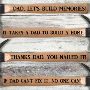 May include: Four wooden hammer handles with black hammer heads. The handles have the following text: "DAD, LET'S BUILD MEMORIES!"  "IT TAKES A DAD TO BUILD A HOME."  "THANKS DAD. YOU NAILED IT!"  "IF DAD CAN'T FIX IT, NO ONE CAN!"