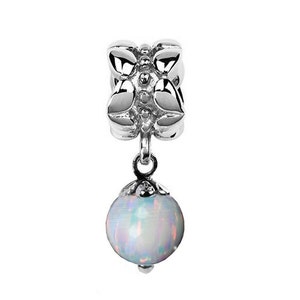 May include: A silver charm with a white opal bead hanging from it. The charm is shaped like a flower with four petals.