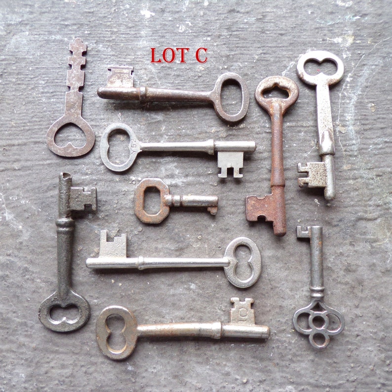 May include: A collection of ten antique keys, some with ornate designs, labeled "LOT C".