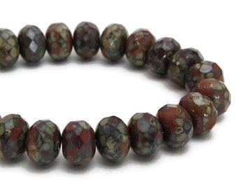 May include: A bracelet made of brown and gray faceted beads. The beads have a speckled pattern.