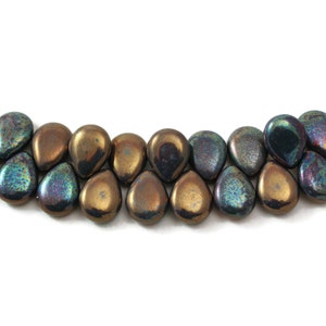May include: A strand of iridescent glass beads in a teardrop shape. The beads are a mix of brown, gold, and blue.