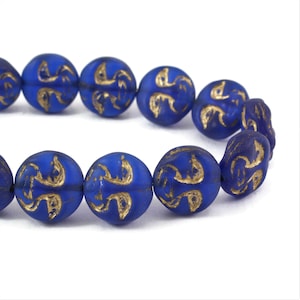 May include: A strand of blue glass beads with gold accents. The beads are round and have a frosted finish.