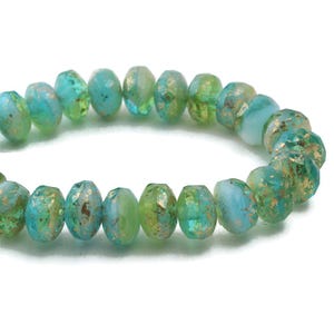 May include: A strand of turquoise and green glass beads with gold flecks. The beads are faceted and have a slightly irregular shape.