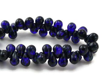 May include: A strand of dark blue glass beads in a teardrop shape.