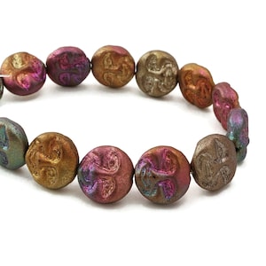 May include: A strand of iridescent glass beads with a faceted design. The beads are a mix of brown, pink, and green.