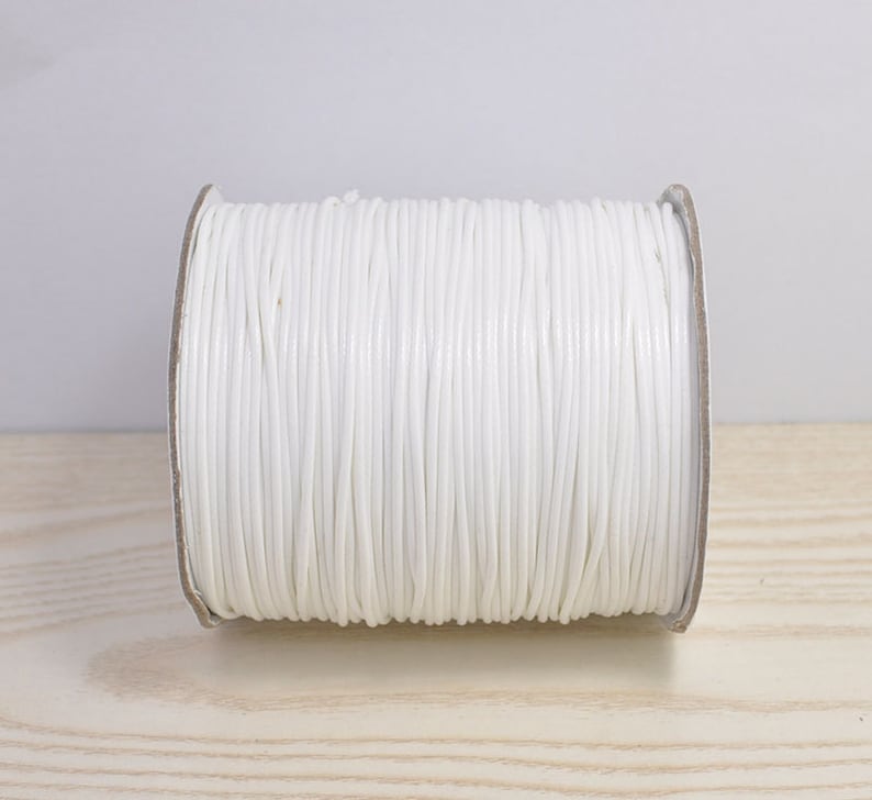 May include: A spool of white waxed cord, perfect for crafting and jewelry making.