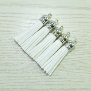 May include: A set of three ceramic nesting bowls with a speckled, off-white glaze. The bowls vary in size, with the largest measuring approximately 6 inches in diameter. Each bowl has a rounded shape and a simple, minimalist design.