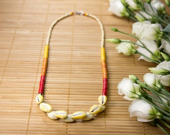 Necklace half-long shells yellow cowries and vinyl from Ghana. Necklace heishis cowries. Yellow-red striped collar. Warm color jewelry