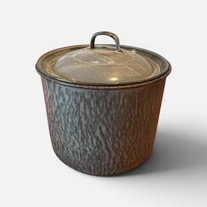 May include: A vintage-style, speckled enamelware pot with a lid. The pot is cylindrical with a dark gray and white pattern. The lid has a metal handle. This kitchenware item is suitable for cooking and storage.