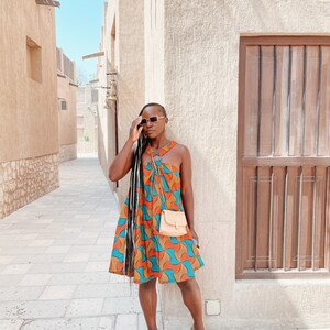 Black Woman Wearing Yellow and Blue African Print Halter Neck Dress from Besida