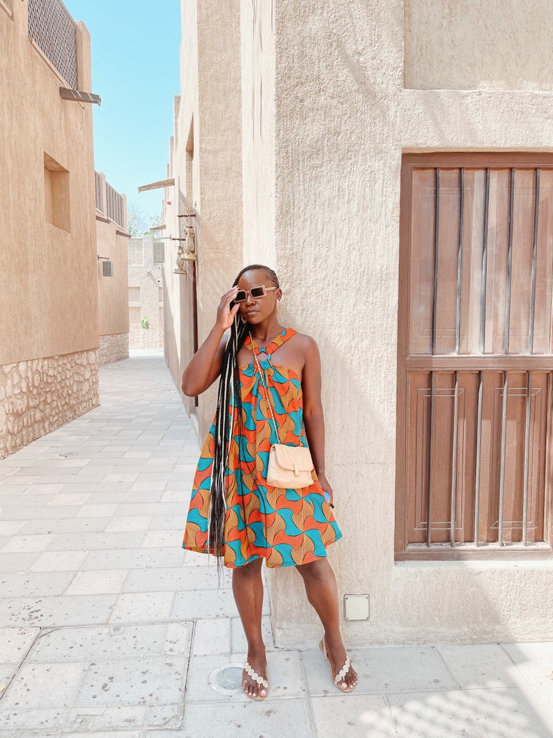 Black Woman Wearing Yellow and Blue African Print Halter Neck Dress from Besida