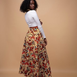 Black Woman Wearing Orange African Print Reversible Wrap Skirt from Besida