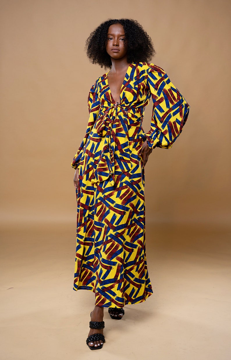 Black Woman Wearing Yellow African Print Wrap Skirt and Wrap Blouse from Besida