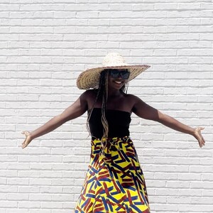 Black Woman Wearing Yellow African Print Wrap Skirt from Besida