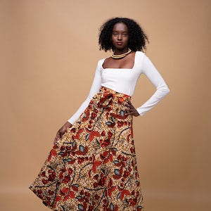 Black Woman Wearing Orange African Print Reversible Wrap Skirt from Besida