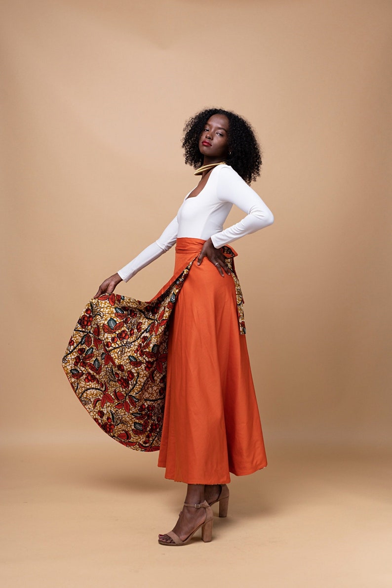 Black Woman Wearing Orange African Print Reversible Wrap Skirt from Besida