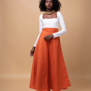 Black Woman Wearing Orange African Print Reversible Wrap Skirt from Besida