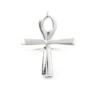 May include: Silver Ankh pendant with a detailed design. The Ankh is a symbol of life and eternal life in ancient Egyptian mythology.