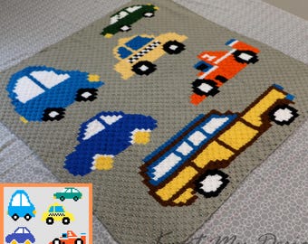 May include: A gray crocheted blanket featuring various colorful car designs. The cars include a blue car, a yellow taxi, an orange race car, a green car, and a yellow bus. The blanket is handmade and suitable for a baby or child.