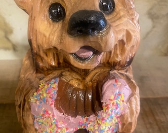 Chainsaw carved bear with strawberry donut. Chainsaw bear carving. Bear sculpture. Wood carved bear.