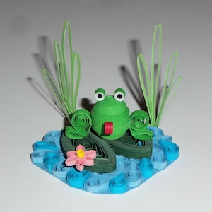 Sapo em um padrão de quilling de almofada de nenúfar