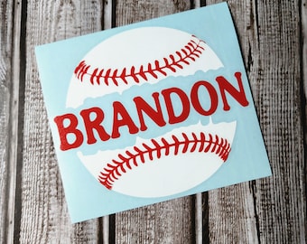 May include: A square light blue decal featuring a white baseball graphic with red stitching. The name BRANDON is printed in bold red capital letters across the center of the baseball, partially obscuring the middle section of the ball design.