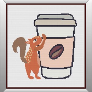 May include: A red squirrel with a bushy tail stands on its hind legs, reaching for a white to-go coffee cup with a brown coffee bean logo. The cup has a beige lid.